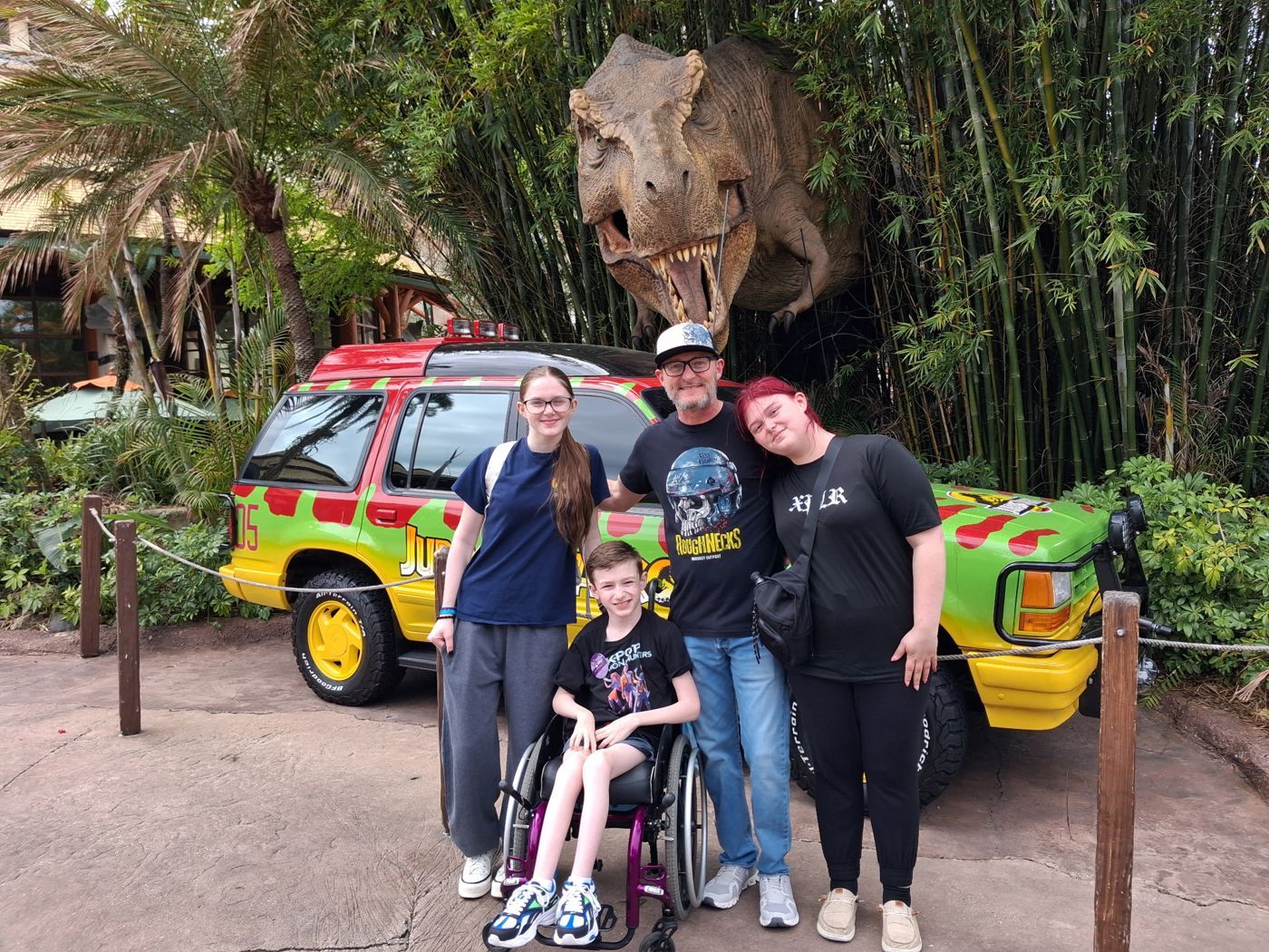 David and his family in front of a T. rex